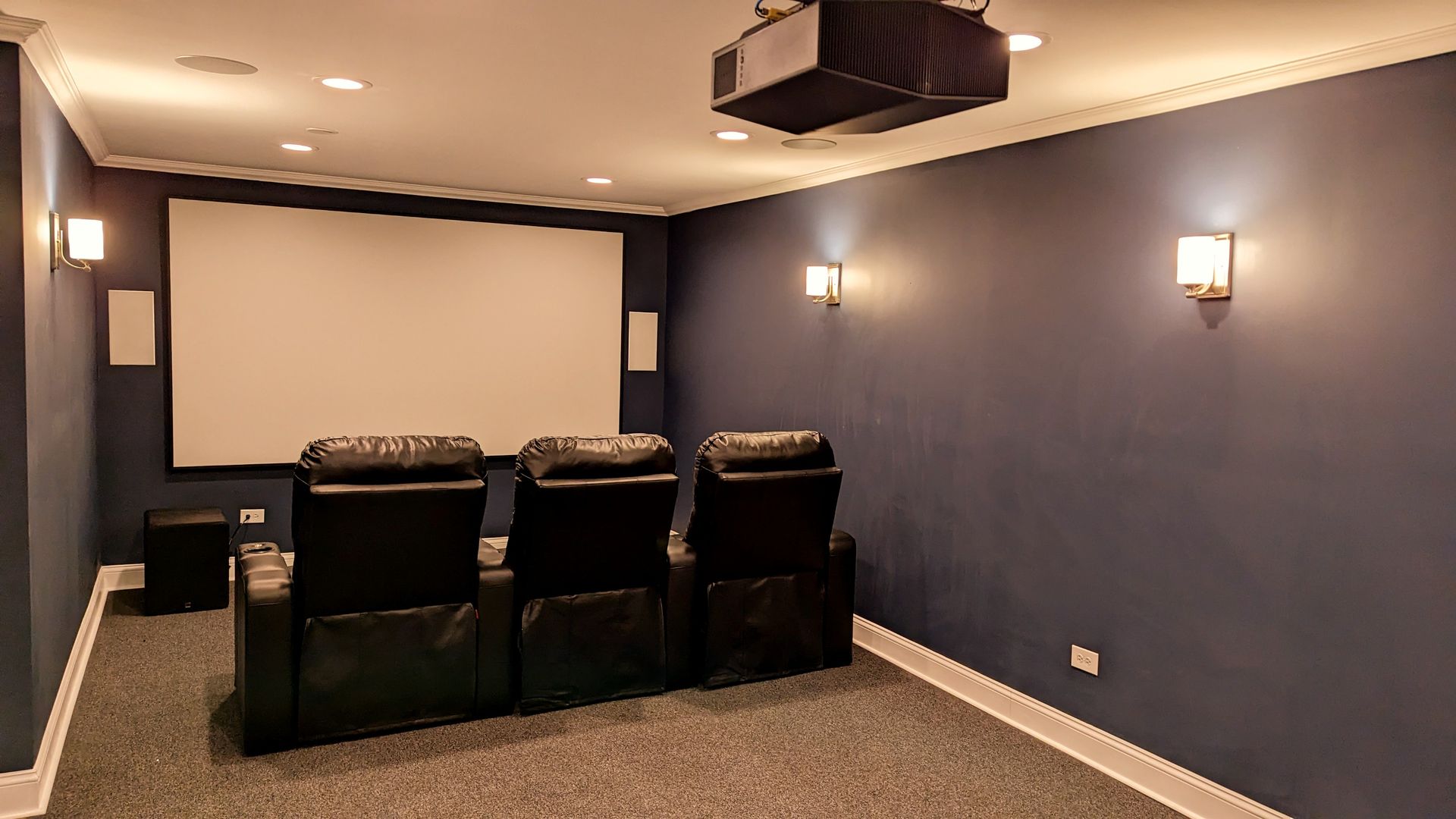 Completed denali basement media room with rack and seating integration